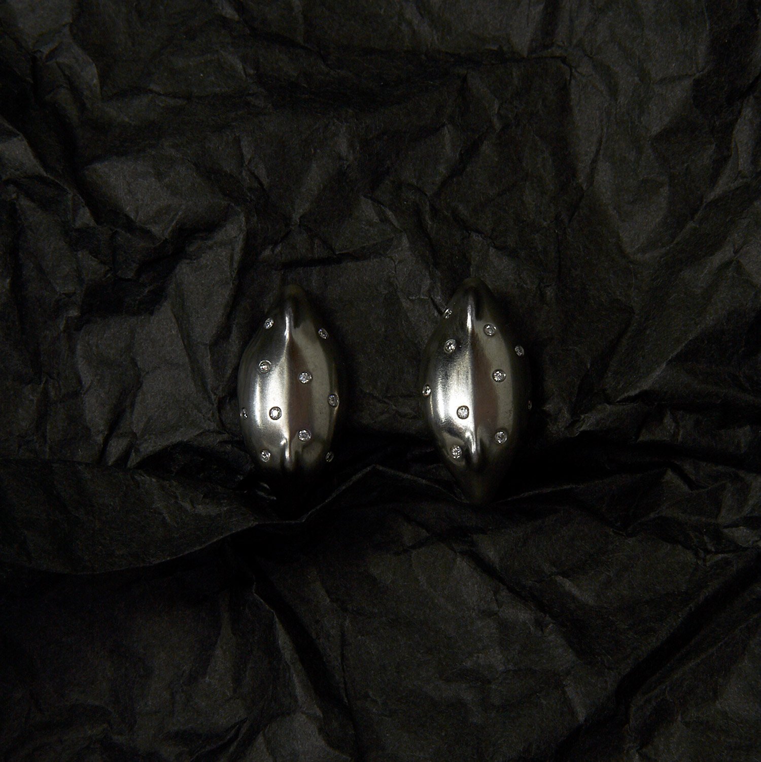 Silver Earrings in form of a giant seed sprayed with 1.2mm diamonds.