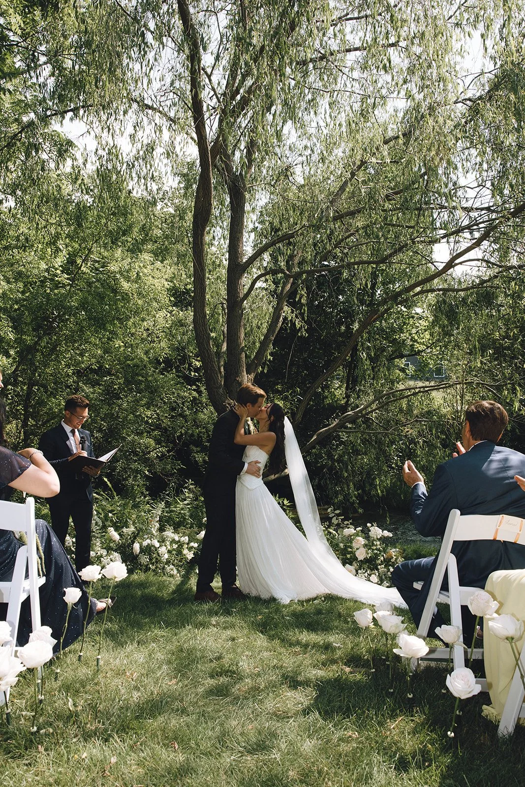 Outdoor wedding ceremony beneath a willow tree at a private home in Upstate New York