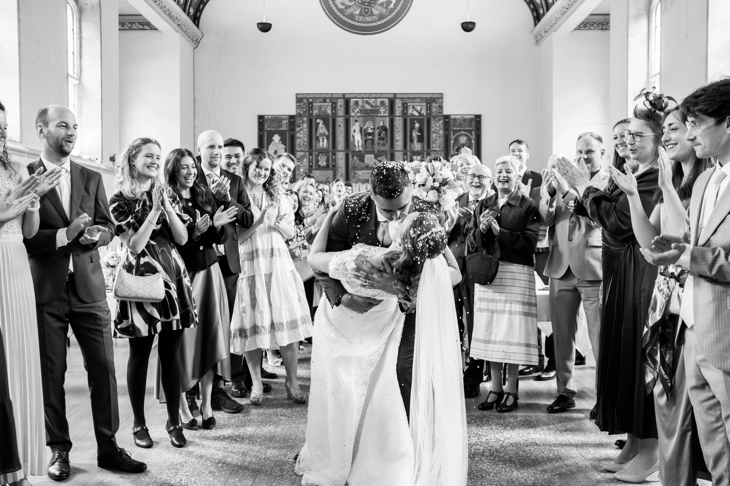 bride and groom dipping down for a kiss in front of all the guests