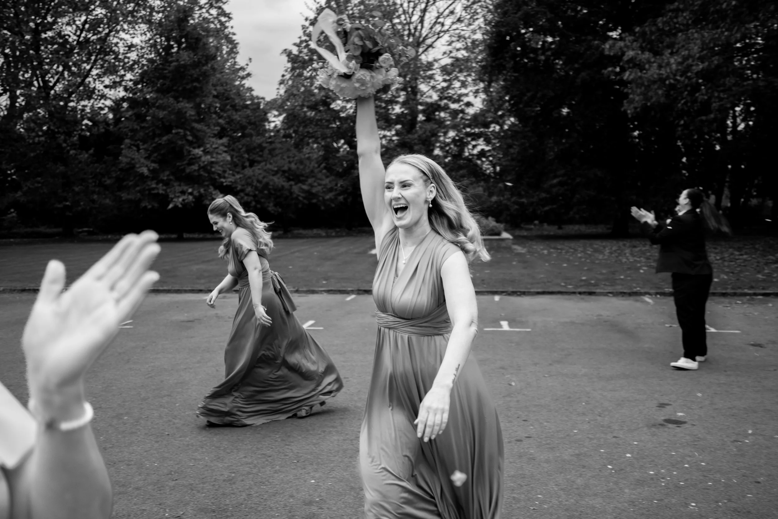 brides sister excited after catching the bouquet after the bouquet toss
