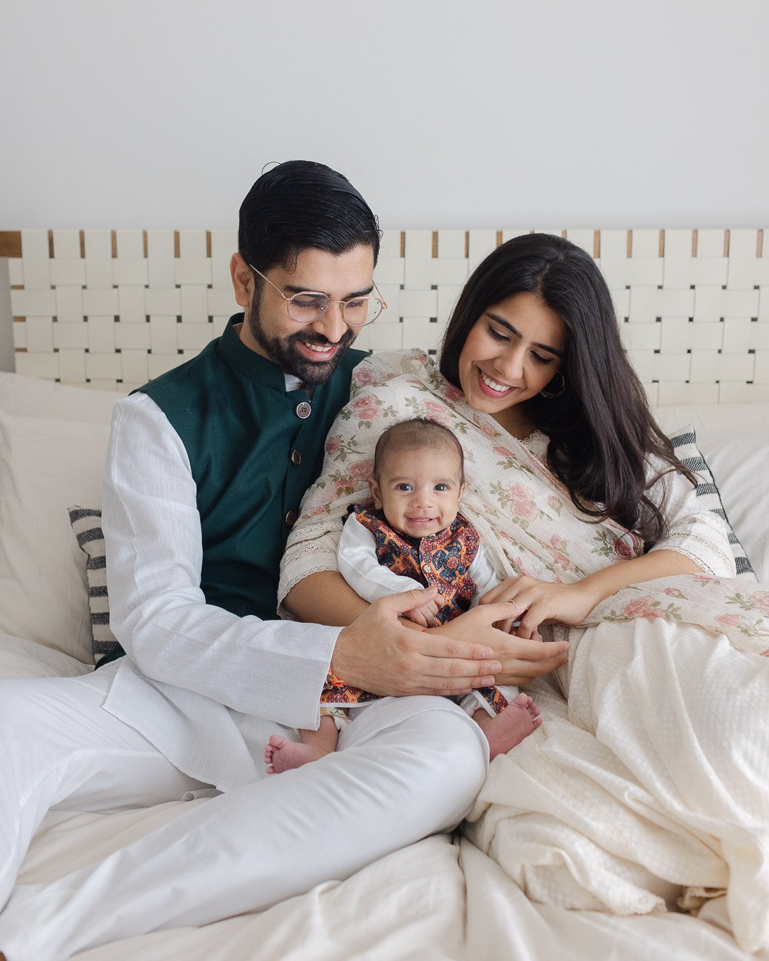Parents holding smiley baby boy on their laps