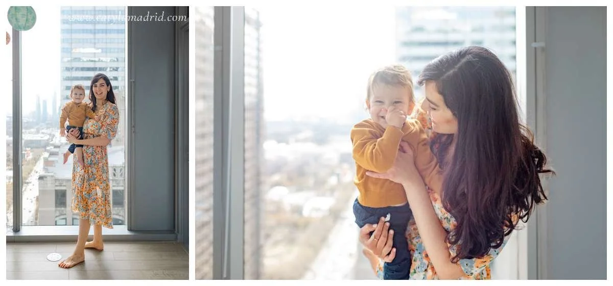 Mom holding baby while standing by window in Chicago