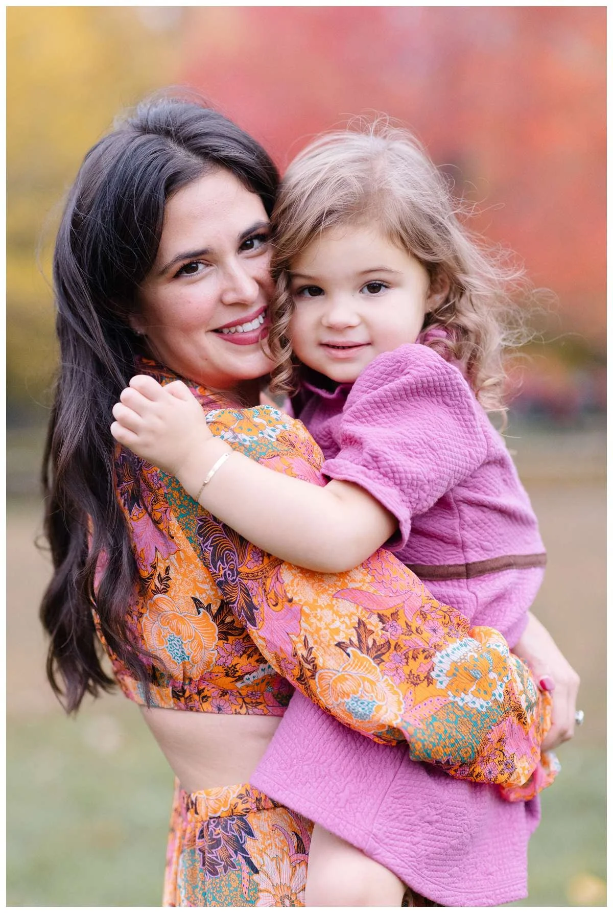 Mom holding little girl in colorful dresses by Chicago Family Photographer