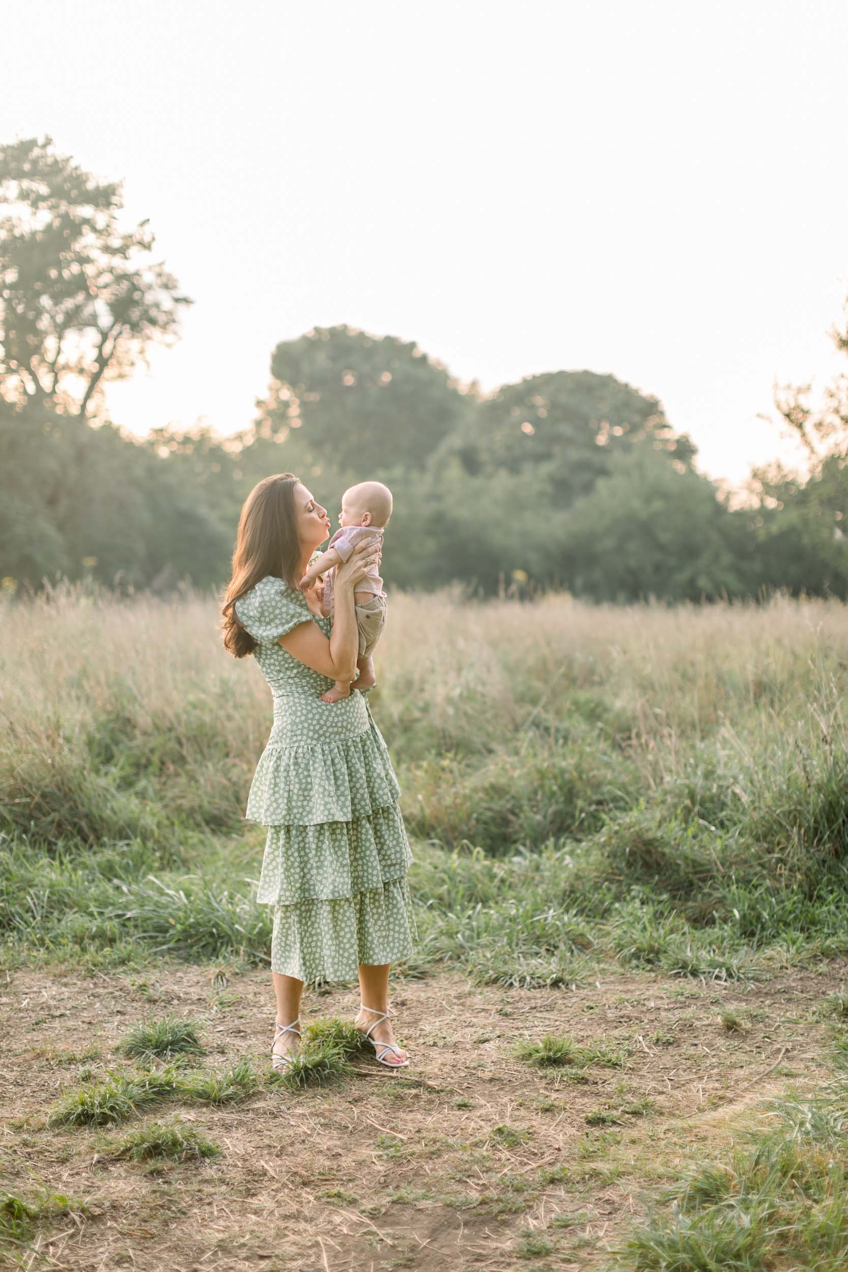 Mother kissing baby boy during Family Photo Session at Montrose Harbor Chicago