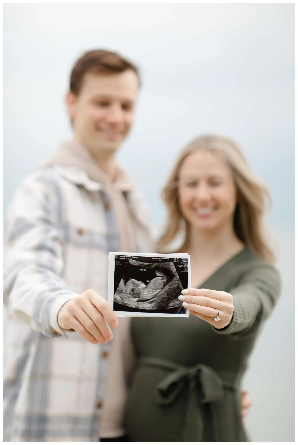 Couple holding image of ultrasound out