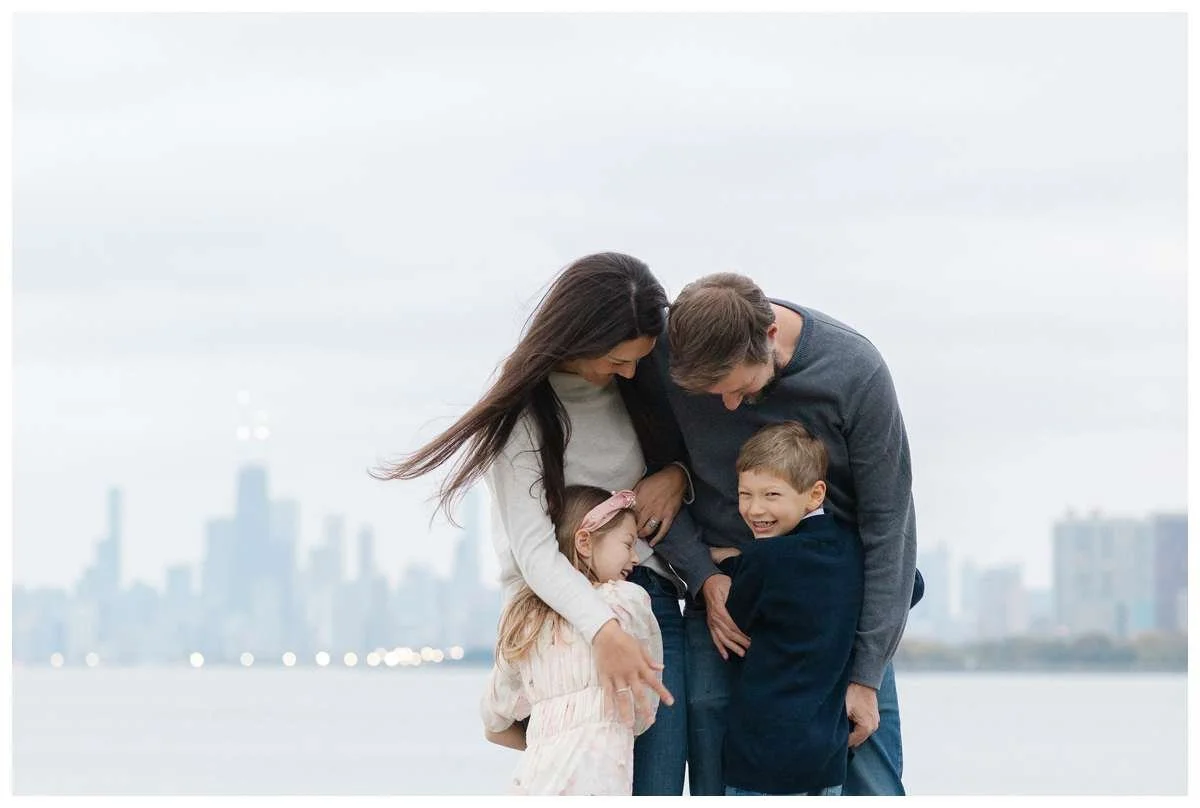 Parents hugging their kids in front of Chicago's skyline
