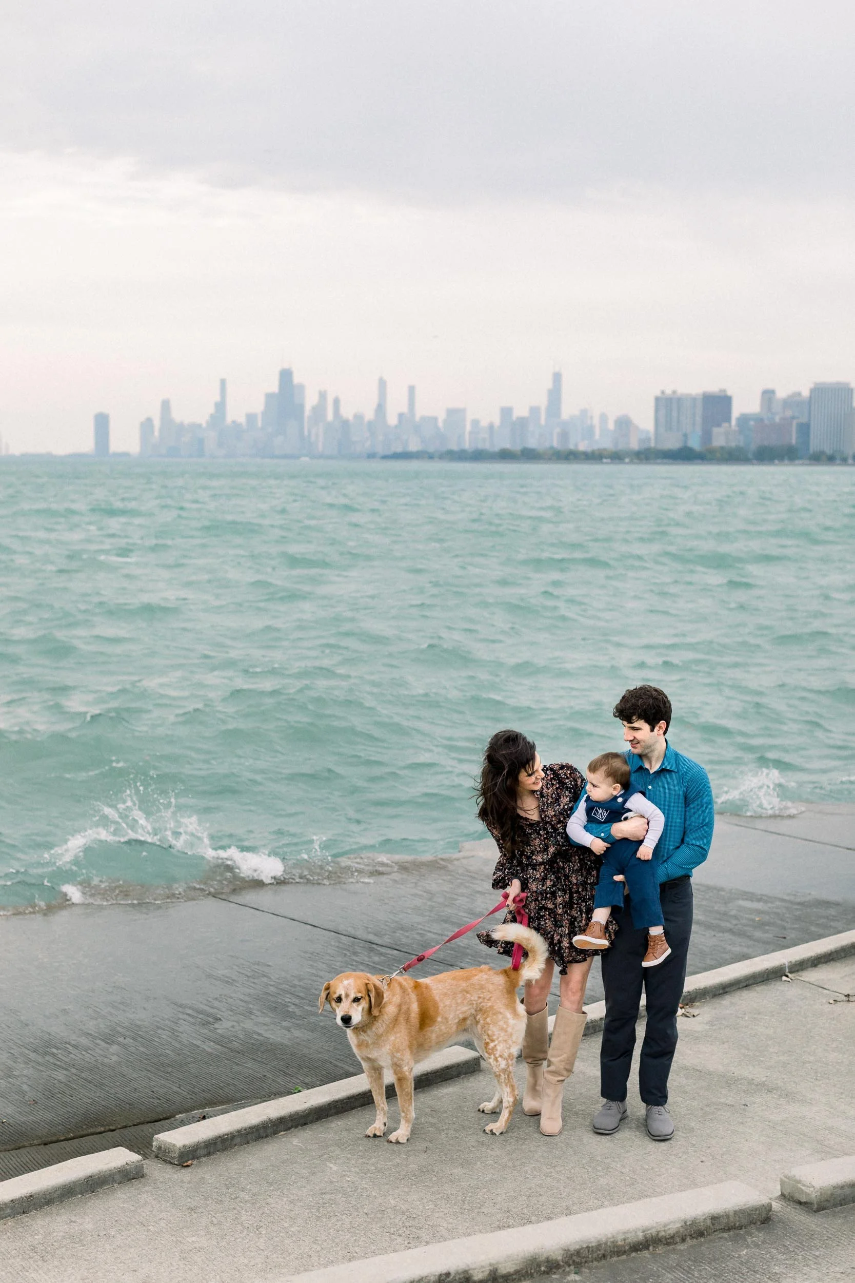 Family and dog in front of Chicago skyline at Montrose Harbor