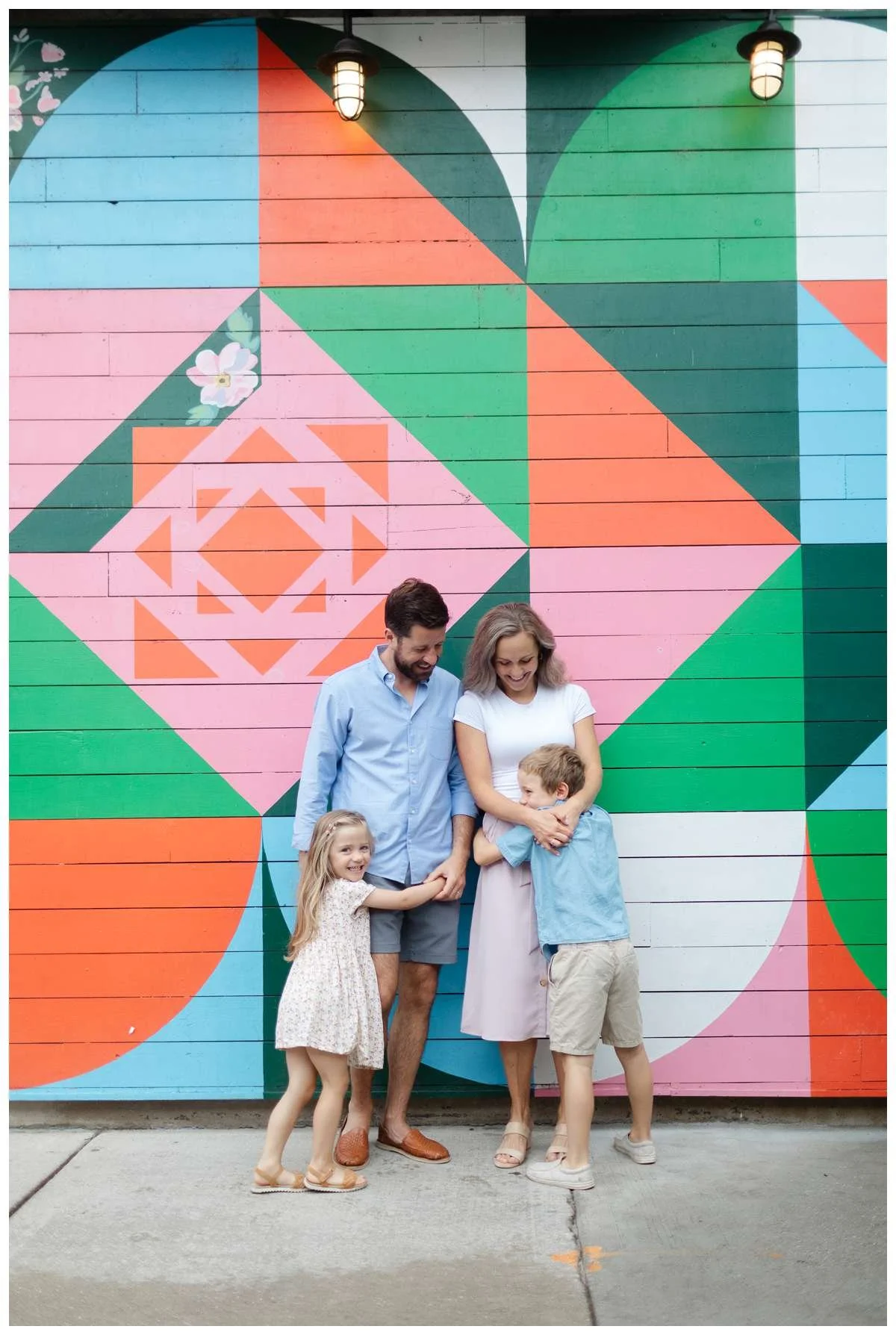 Southport Corridor mural with family playing in front of it by Chicago Family Photographer