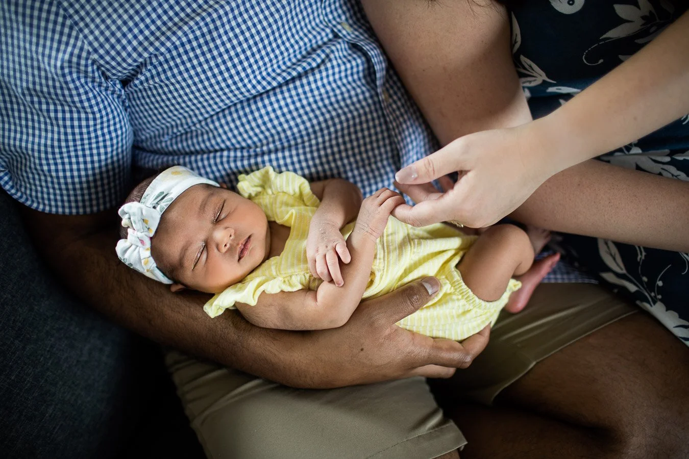 Newborn girl being held by parents