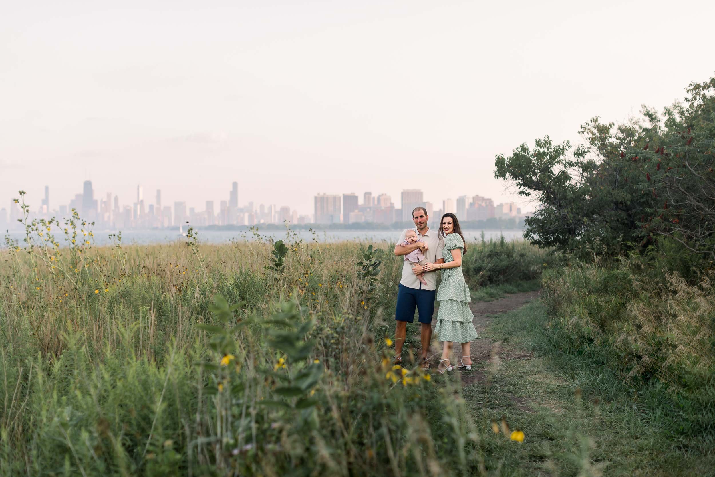Parents and their baby along a path of wildflowers