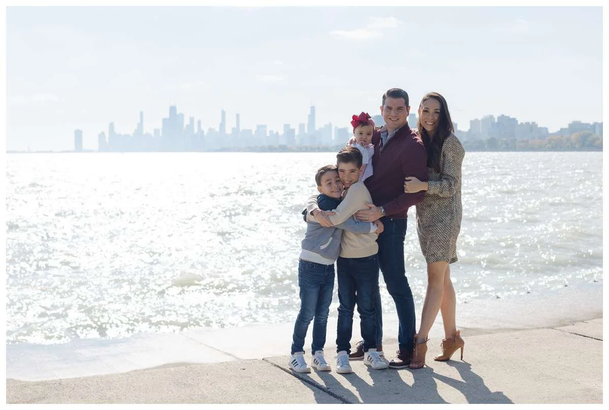 Family of five posing against Chicago skyline