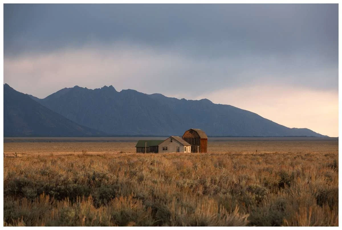 Stormy clouds behind Mormon Row houses at Grand Tetons National Park