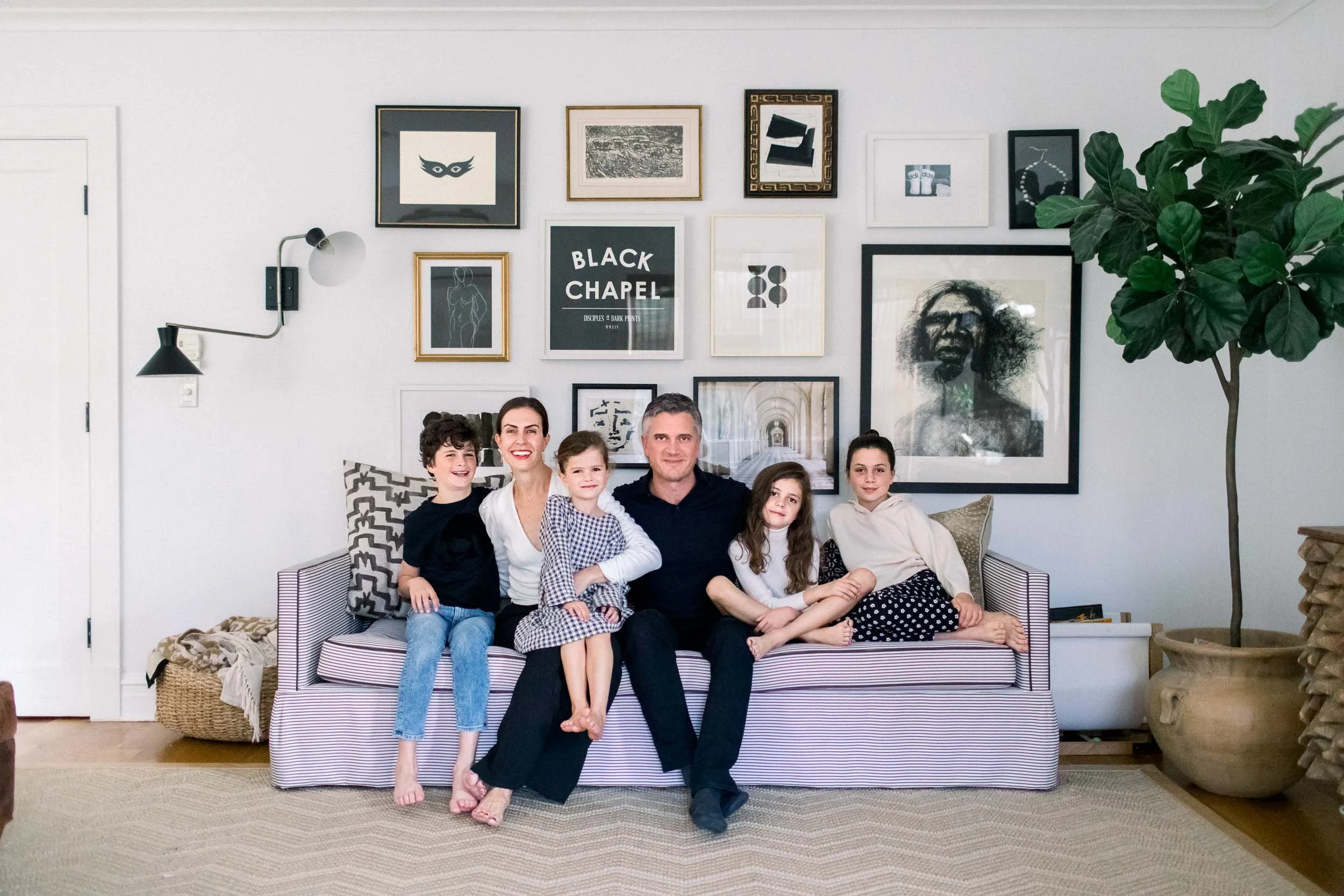 Family sitting on stylish couch during in-home family session