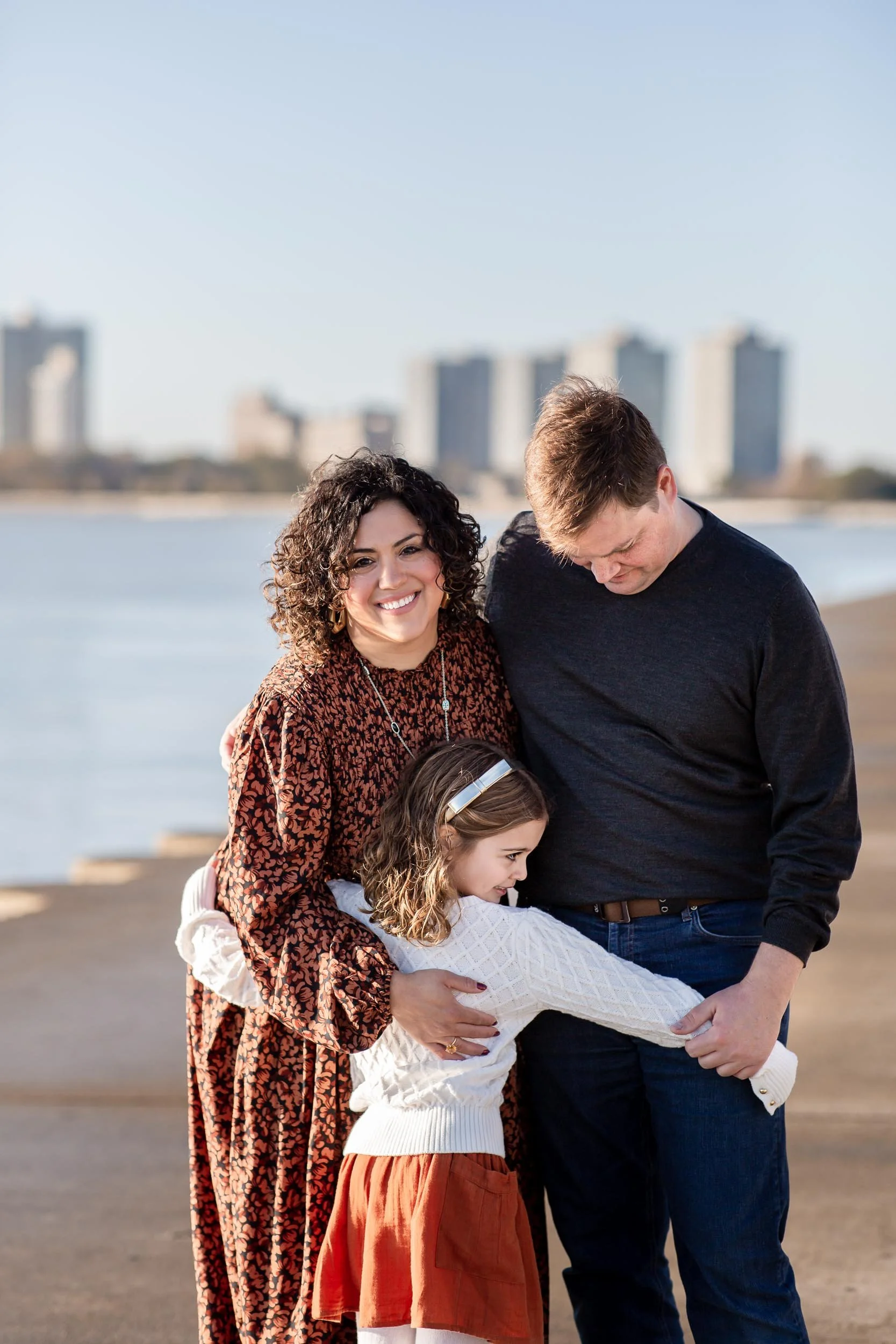 Girl hugging her parents