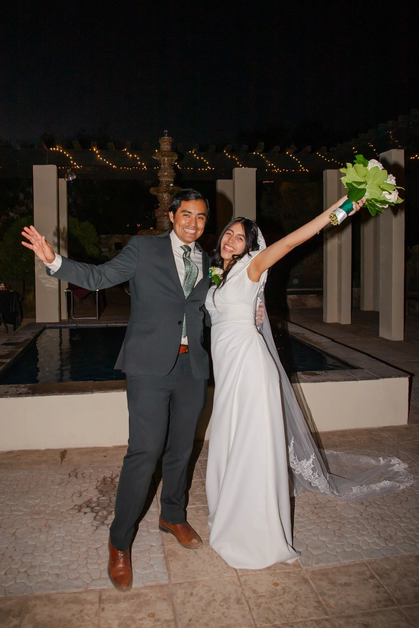 An El Paso, Texas couple portrait of a bride and groom cheering during their outdoor wedding at Keystone Heritage Park.