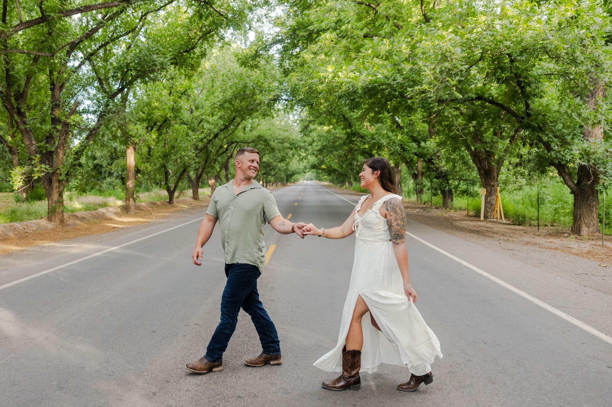 An El Paso, Texas engaged couple walking down the Mesilla Valley trees in Las Cruces, New Mexico.
