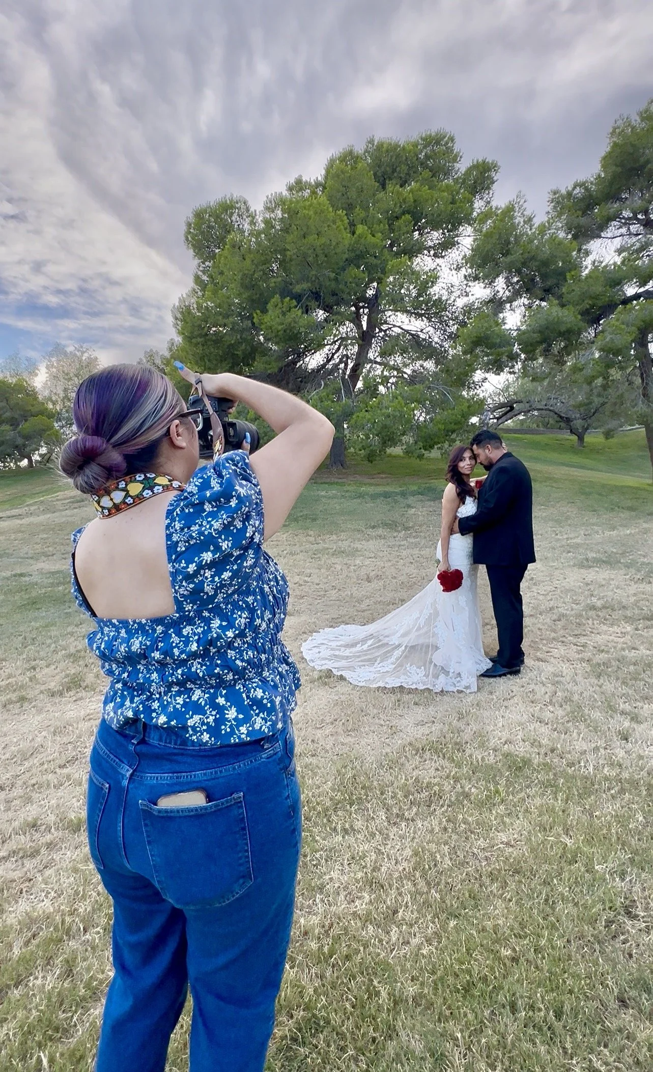 El Paso, Texas Wedding photographer taking photos of a bride groom at Memorial Park surrounded by trees and greenery.