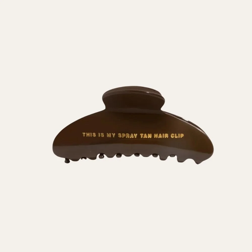 “This Is My Spray Tan Hair Clip” | NUDA — $16.00 