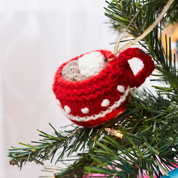 knit hot cocoa mug ornament hanging on a tree