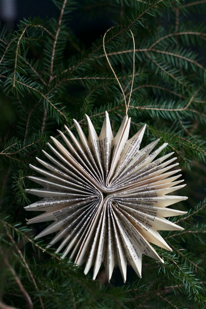 paper pinwheel ornament on a tree made from book pages