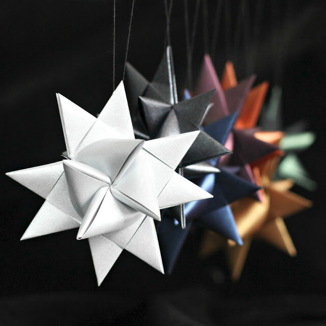 several german star ornaments in different colors of paper