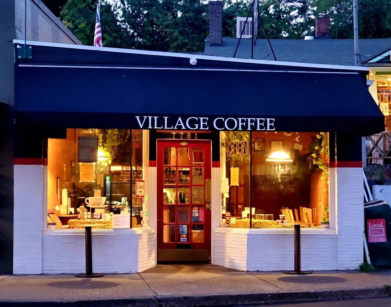 Storefront of Village Coffee at night