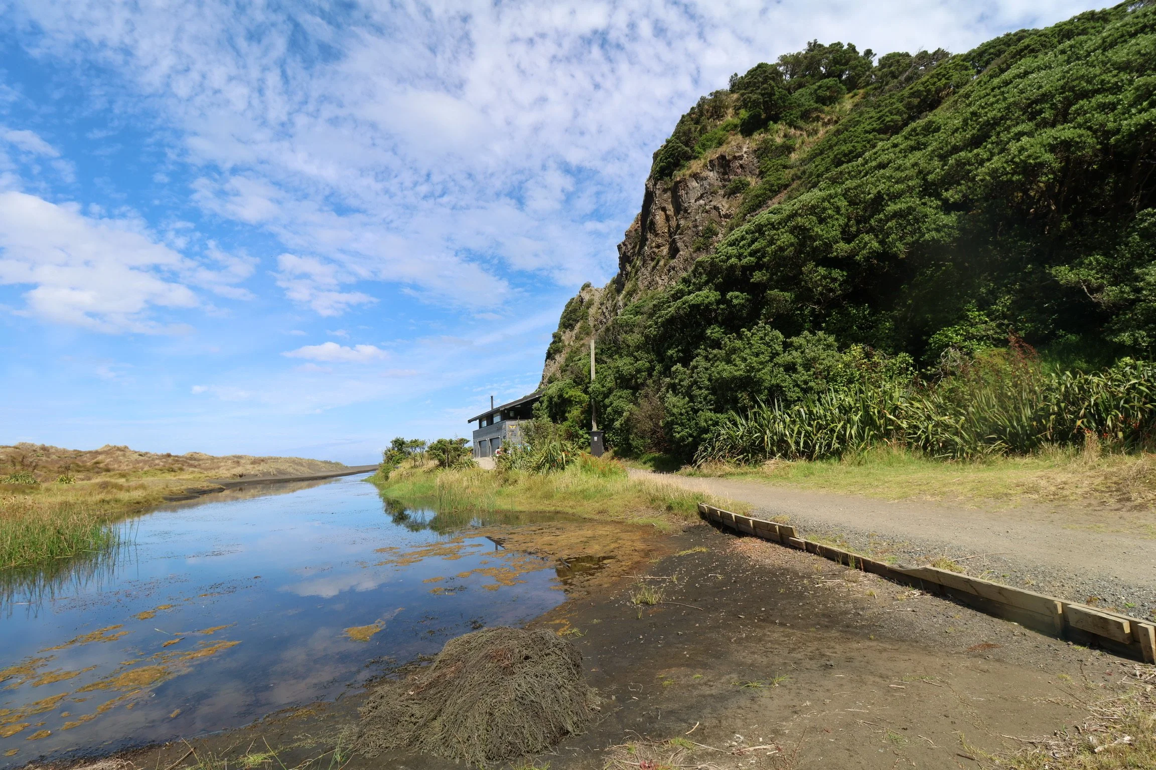 Stand inside a section through a volcano at Karekare and look around.