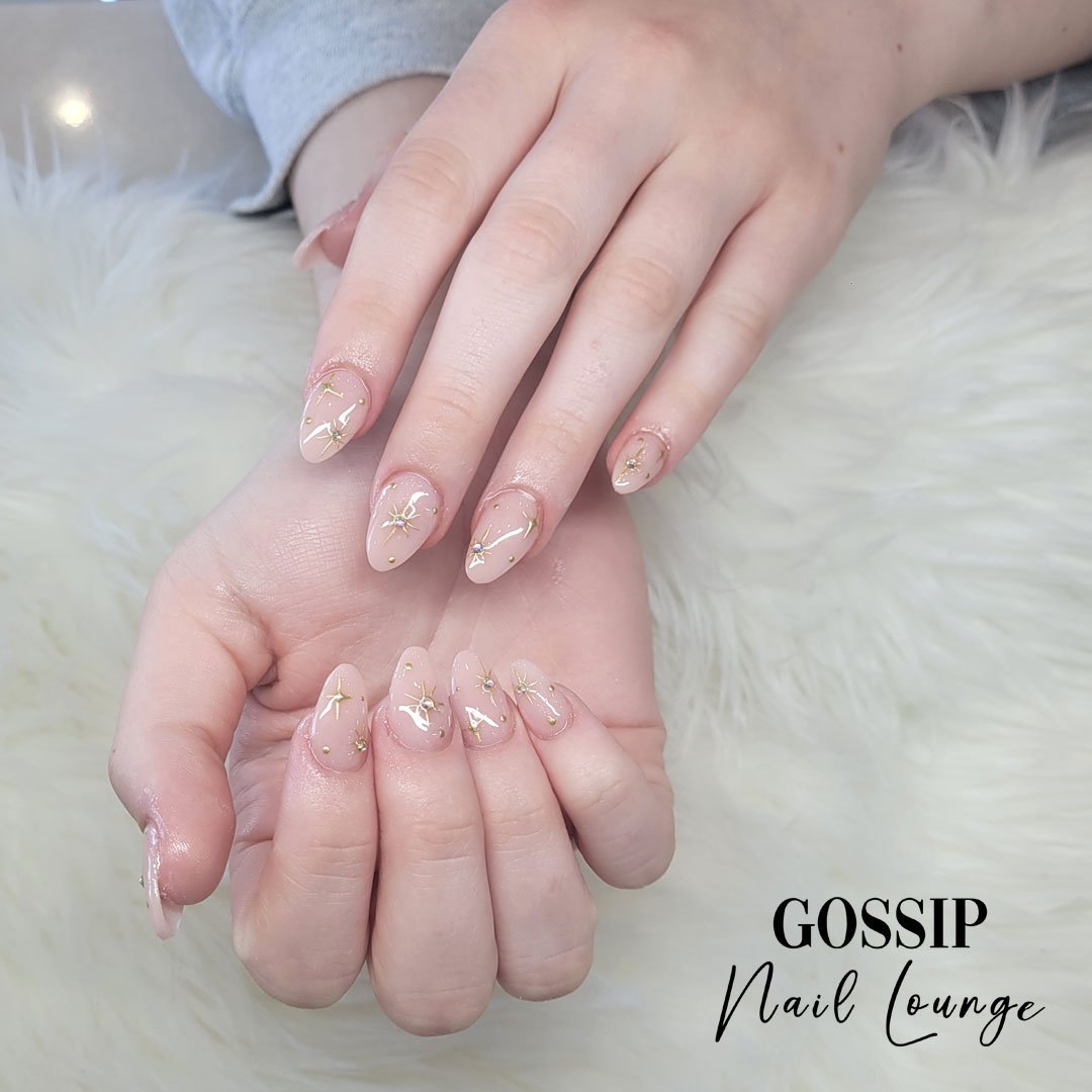 Transform your nails into a heavenly sight with celestial nail art that is truly out of this world. Embrace the cosmic beauty and let your nails shine like the stars above! #stars #goldenstars #nails #gossipnaillounge #leessummit