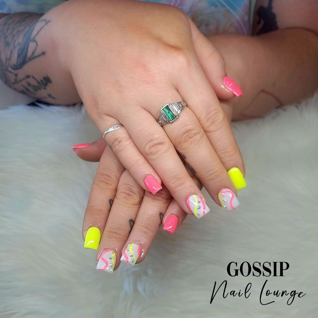 Transform your nails into a stunning masterpiece with our range of vivid neon colors. Elevate your beauty game with these amazing hues that will brighten up your set of nails like never before #neoncolors #optic #leessummit #gossipnaillounge #neon