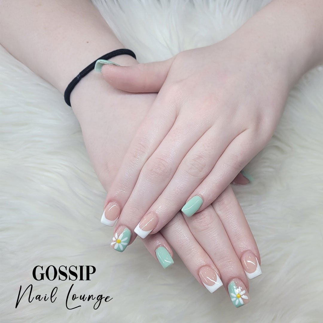 With a mint green and white set of nails adorned with beautiful floral and French tip designs, you'll undoubtedly turn heads and make a lasting impression.#flowers #nailsnailsnails #minty #frenchtipnails #gossipnaillounge #leessummit