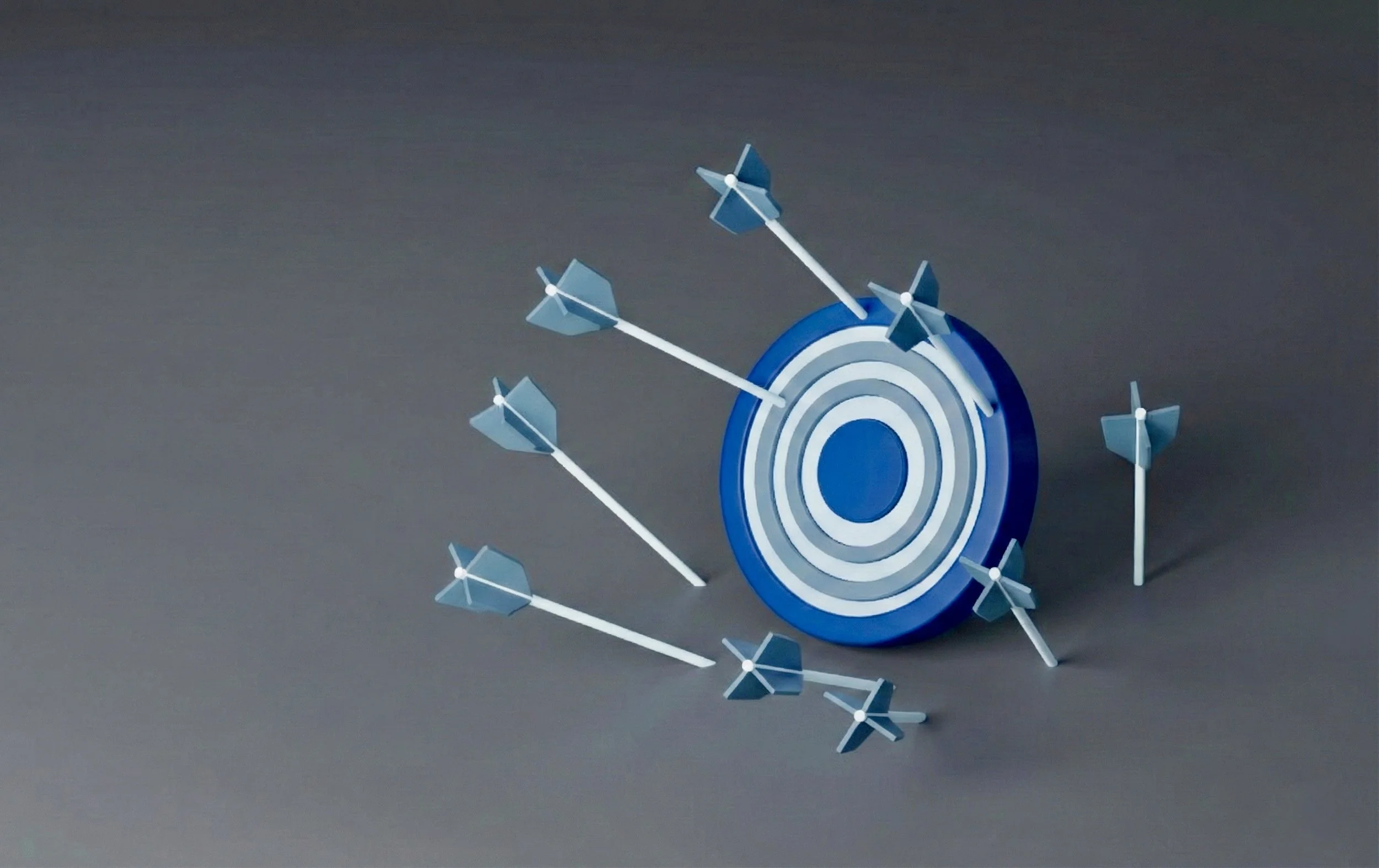 A blue archery target with several arrows scattered around it, most of which have missed the center, illustrating the challenge of precise strategy execution in a retail environment.