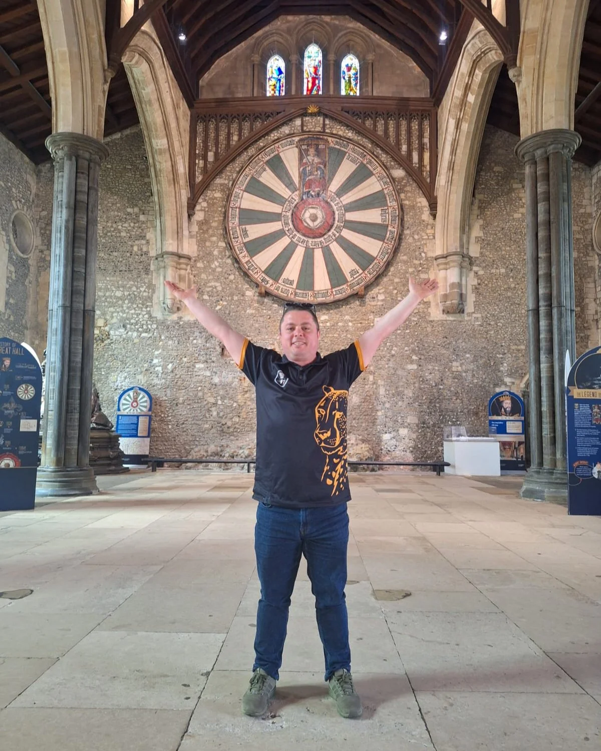Man standing in front of Round Table with hands up