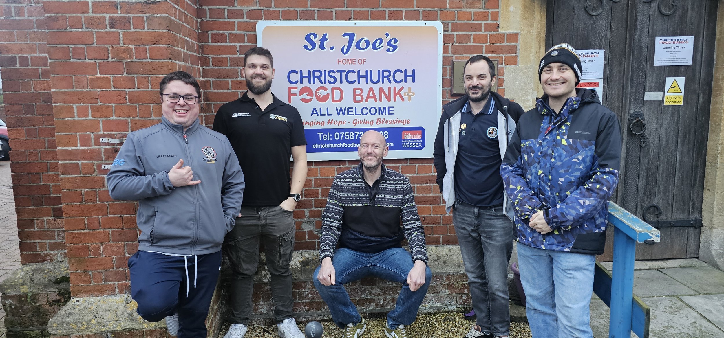 Group of men from Christchurch Round Table stood outside Christchurch Foodbank