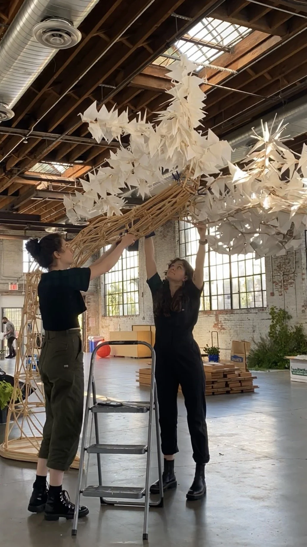 Rose and Camille Labarre installing a custom sculpture (Fabricator for LAB LAB)