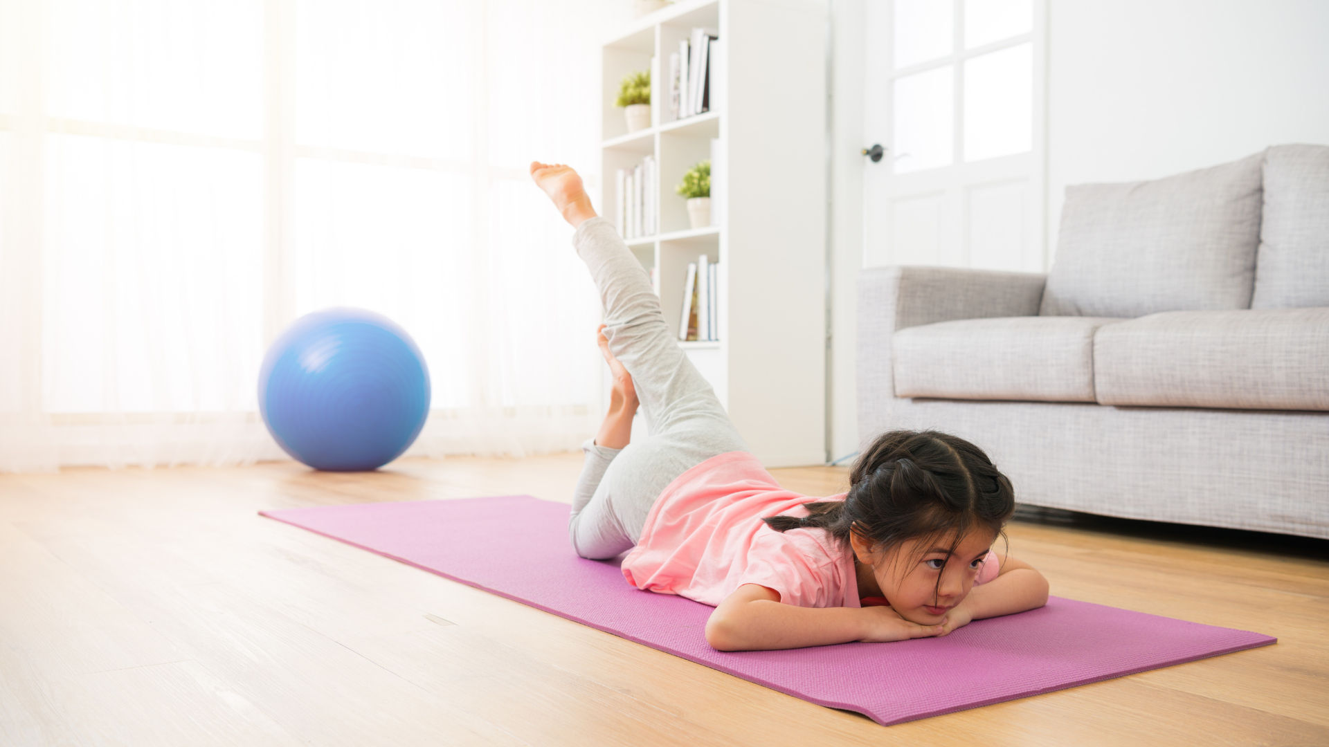 toddler on a yoga mat doing yoga