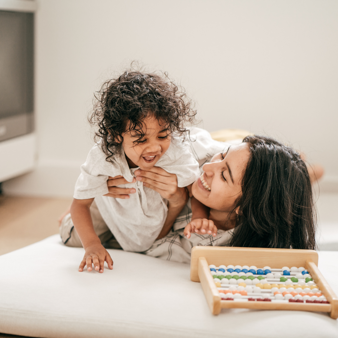 toddler and adult playing