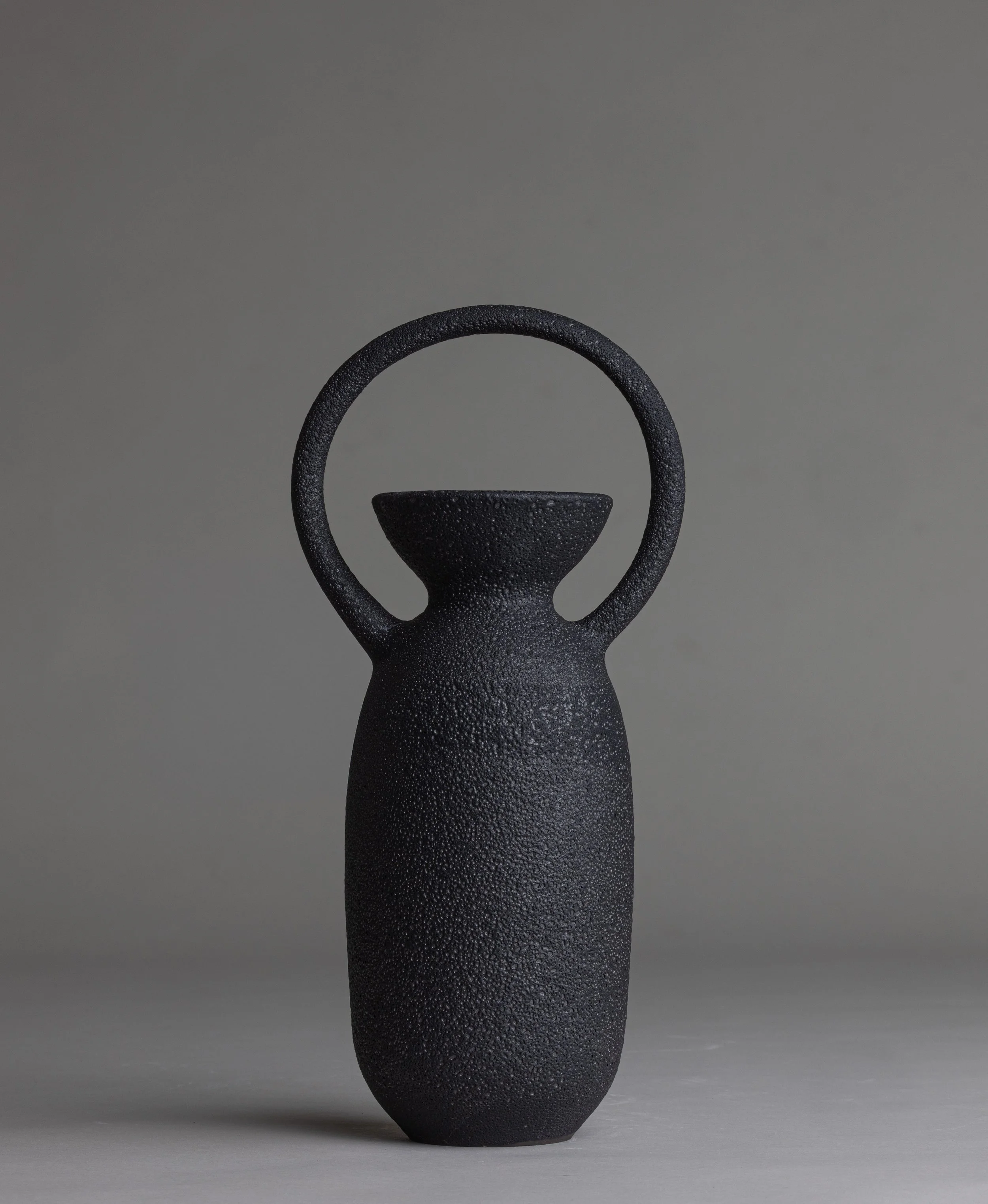 23. 
 medium black handle vase  
$ 