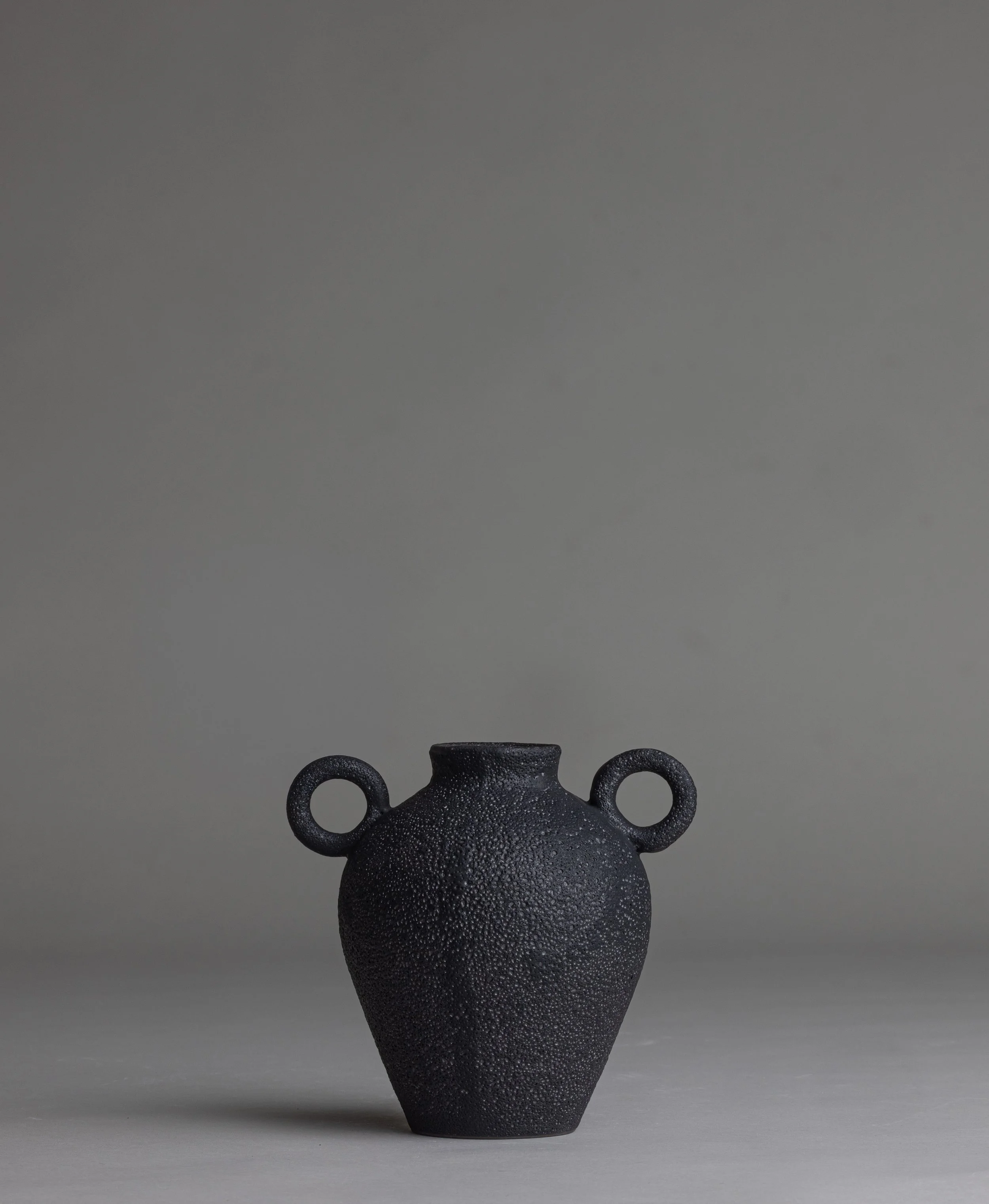 20. 
 small black handle vase  
$ 