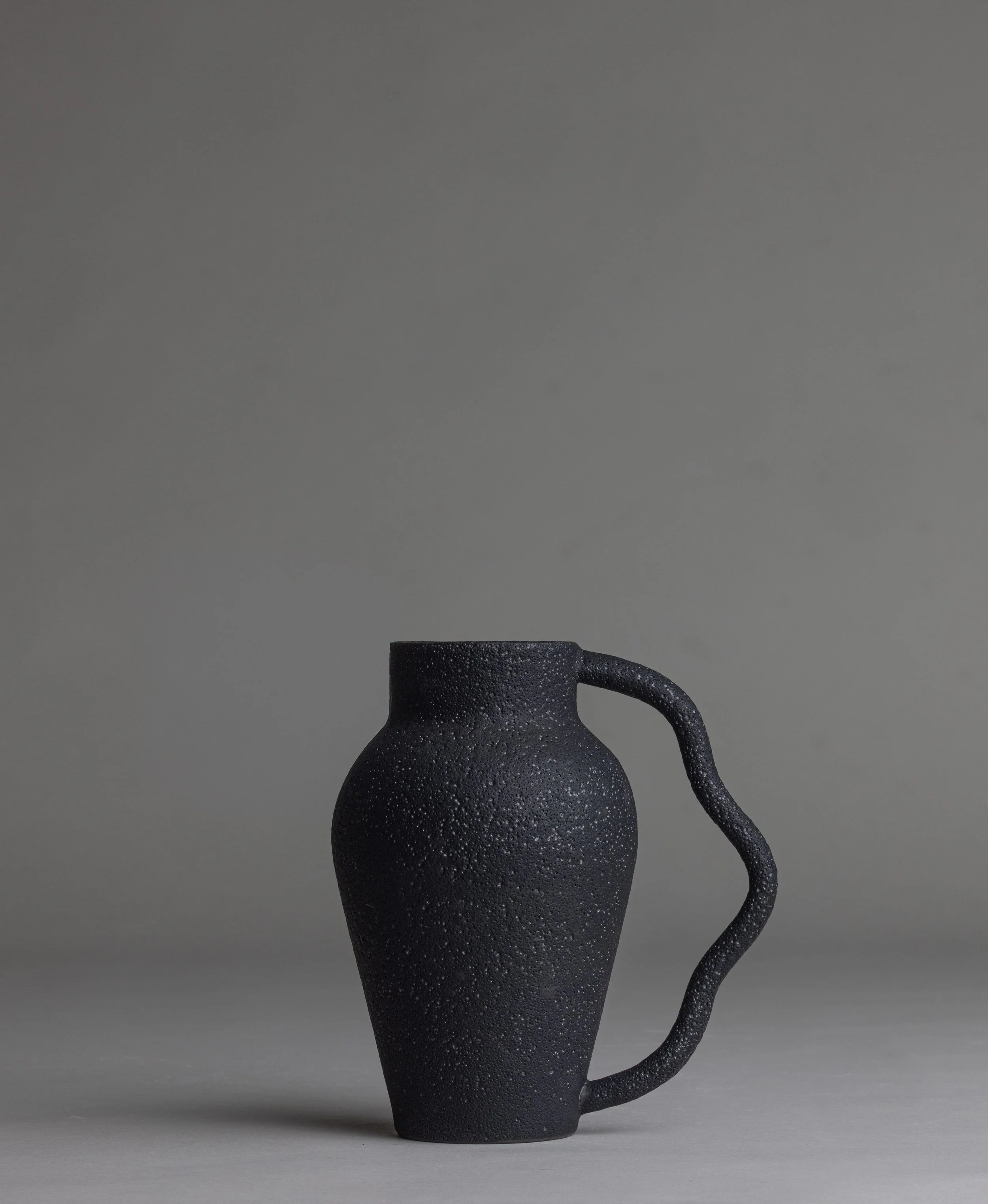 22. 
 small black wavy handle vase  
$ 