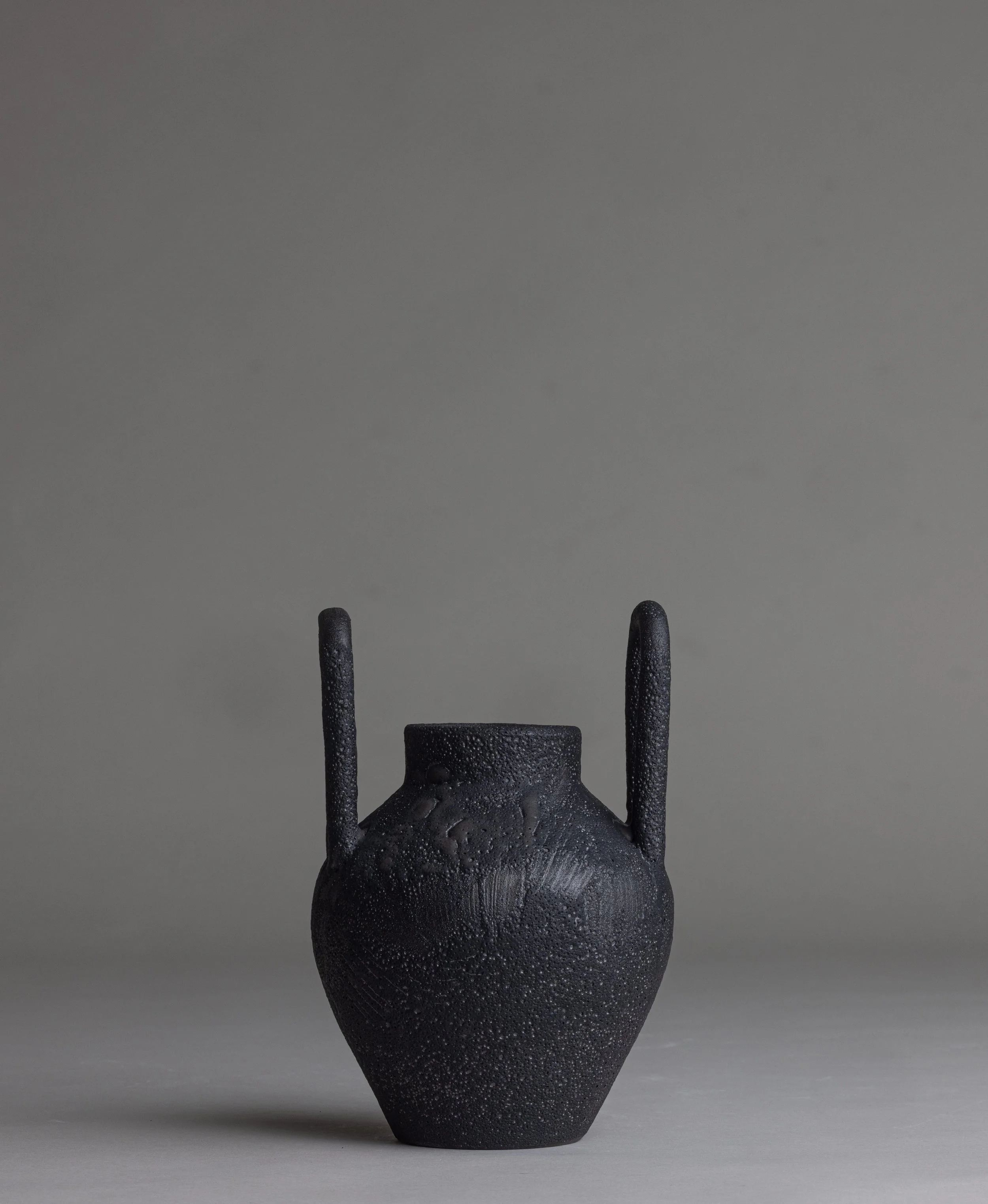 21. 
 small black handle vase  
$ 
