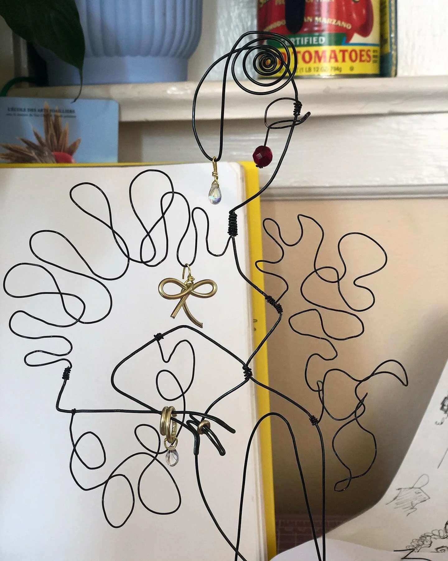 Another original piece featured in the doc: this wire sculpture of yours truly. It&rsquo;s comprised mainly of 2 long pieces of wire. This was a challenging project, but fun. Accents include a single ruby bead for the lips &amp; a contrasting gold wi