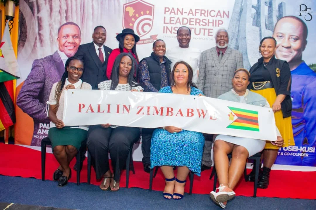 Group of people holding a banner that says "PALLIN ZIMBABWE" with Zimbabwe flag, at a Pan-African Leadership Institute event. Background features large portraits and the institute's logo.