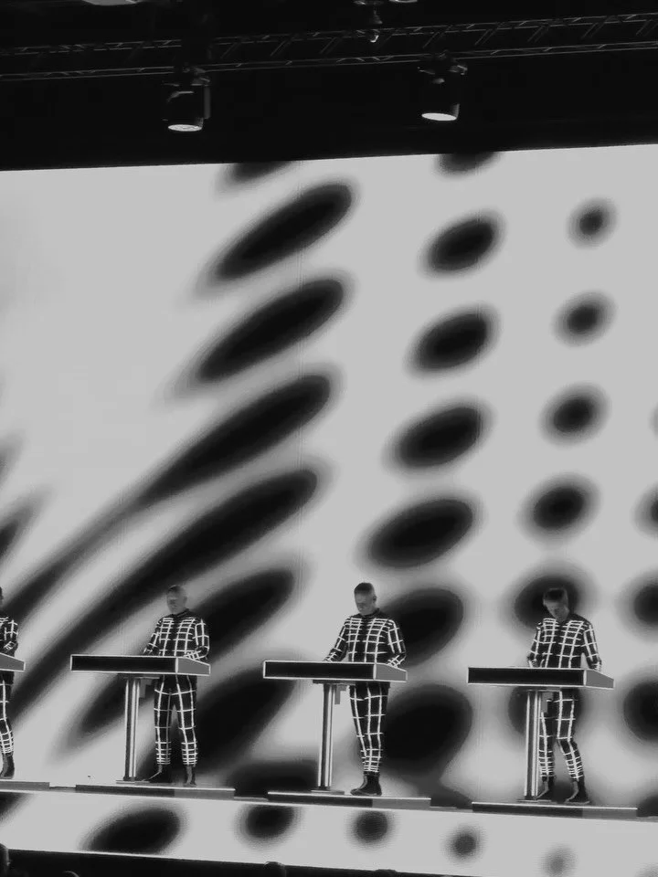 @kraftwerkofficial in Bangkok last week. Four men in matching uniforms standing behind consoles with almost monastic restraint, while entire worlds unfolded across the screens behind them. Geometry, highways, data, trains, neon grids, the romance of 