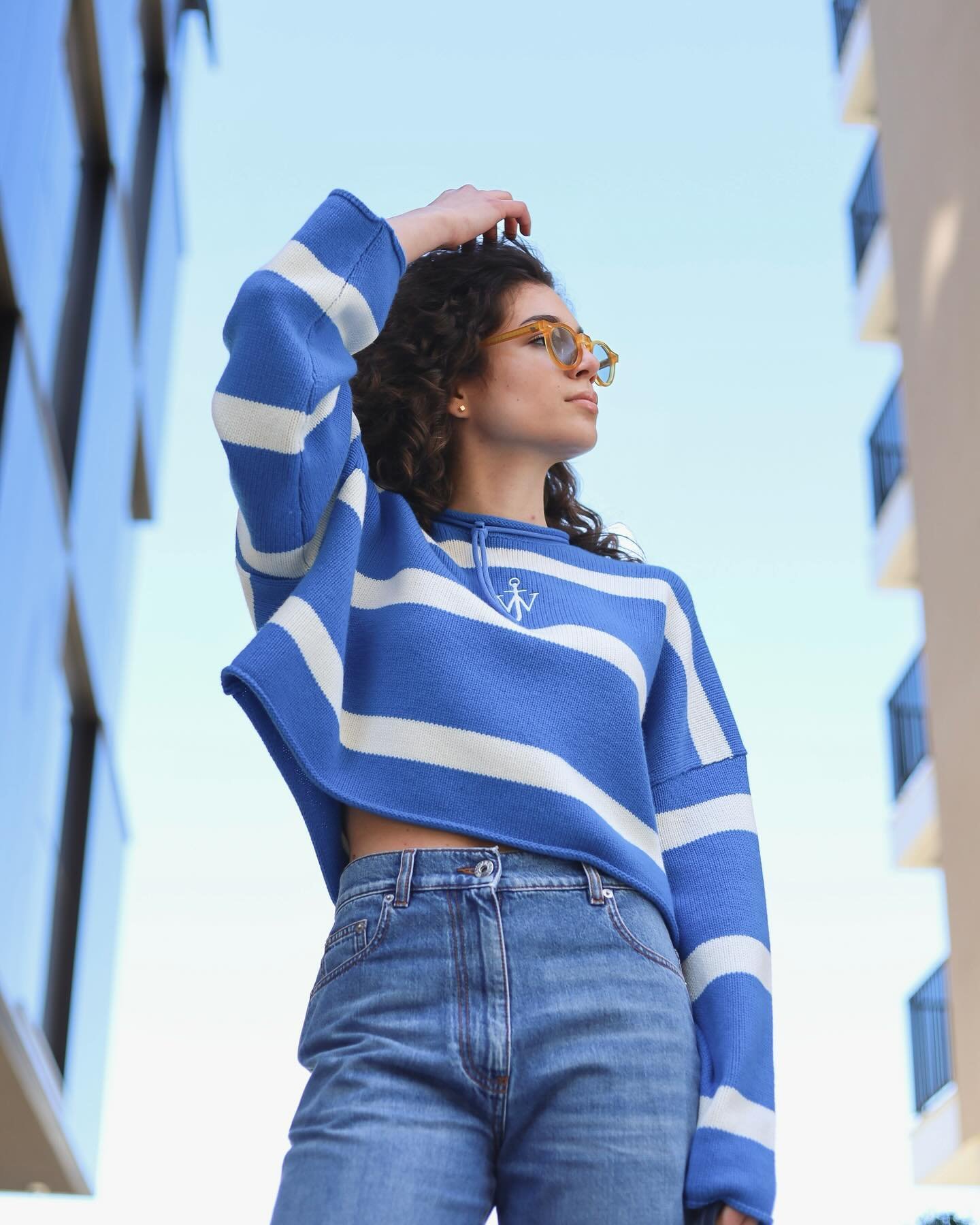 Fresh, urban and cool 💙🤍

Our #OOTD will brighten up this moody weather🌦️ and keep you stylish this spring. 

&bull;Cropped jumper, cut out knee jeans and bag all @jw_anderson 
&bull;Sneakers @santoniofficial 
&bull; Sunglasses @tbdeyewear 

Check