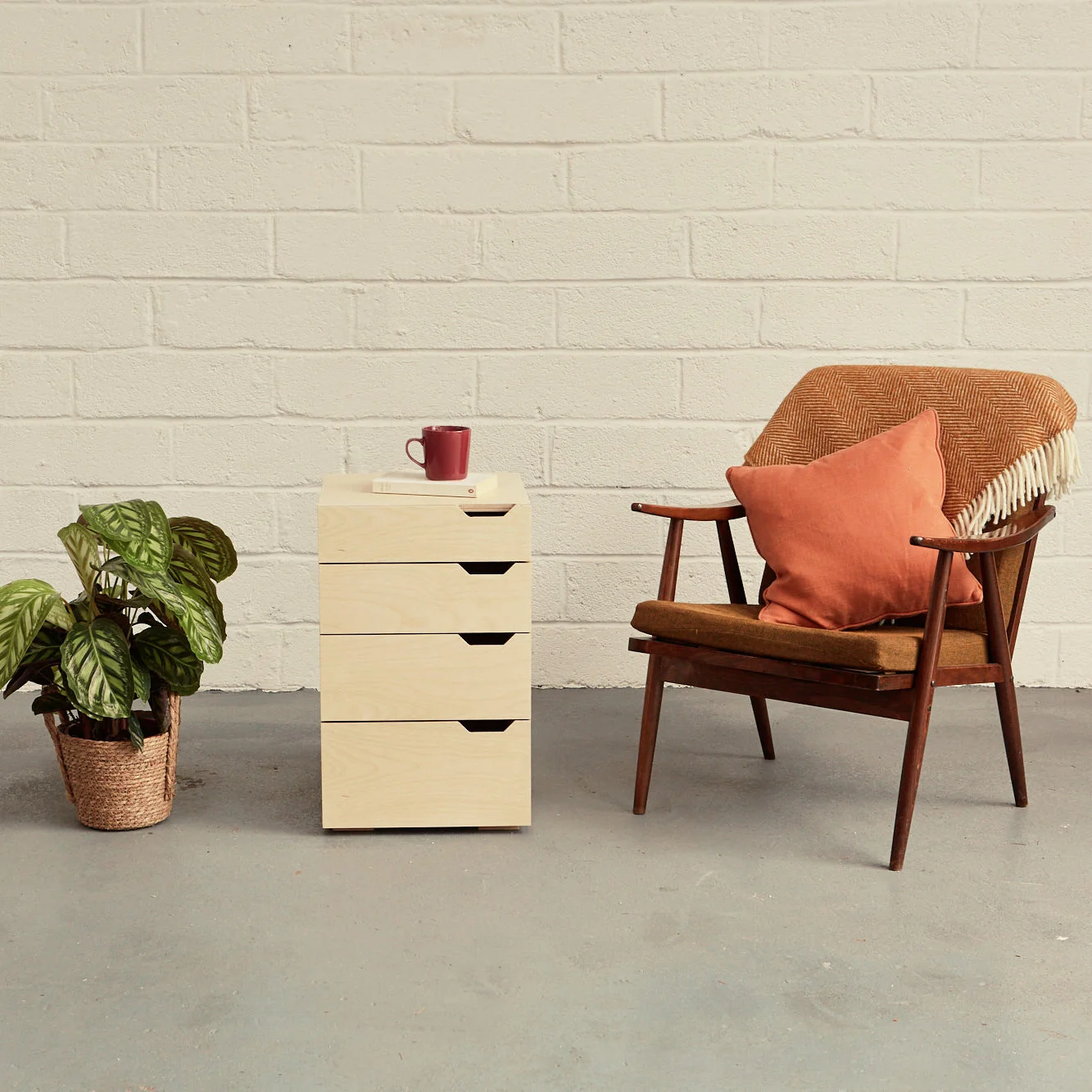 filing cabinet with plant and armchair