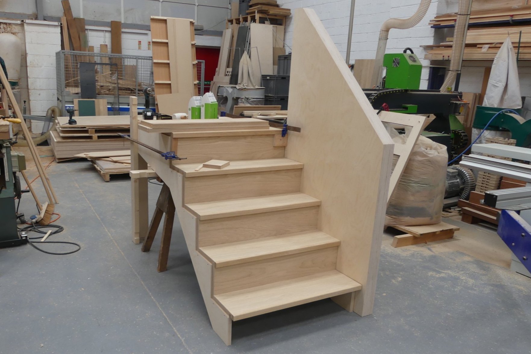 oak and plywood staircase in construction in big workshop