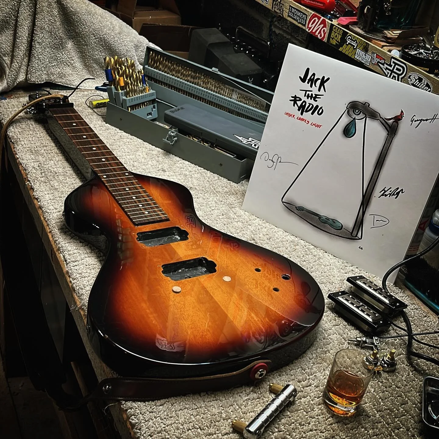 Working on a lapsteel tonight. Basically, an overhaul / upgrade. 

Plugging bridge post holes for new bridge. I&rsquo;ll flush these mahogany plugs tomorrow when the glue dries. The drill for new studs. 

Also, complete rewire with new pickups and ha