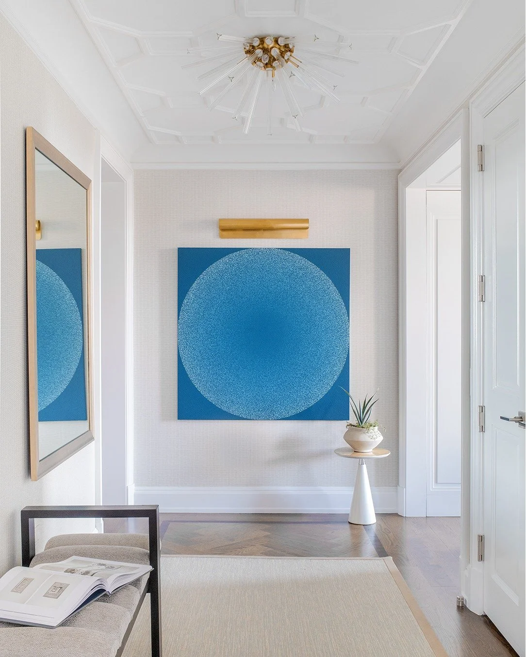 In New York apartments, every square inch becomes valuable real estate for design. Here, we gave this hallway its own moment. Even though its primary purpose is simply to connect the surrounding rooms, we added a beautiful geometric ceiling detail an