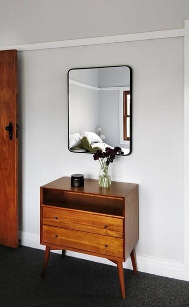 modern rectanglur mirror hanging over console table.jpg