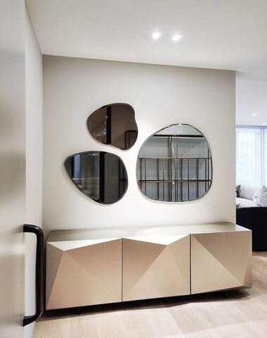 organic shape mirrors hanging in arrangement over console table.jpg